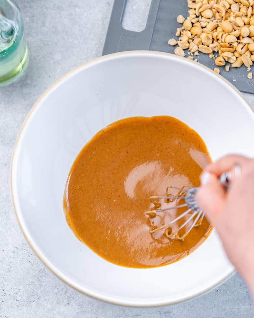 Mixing the Thai Salad Dressing with a whisk.