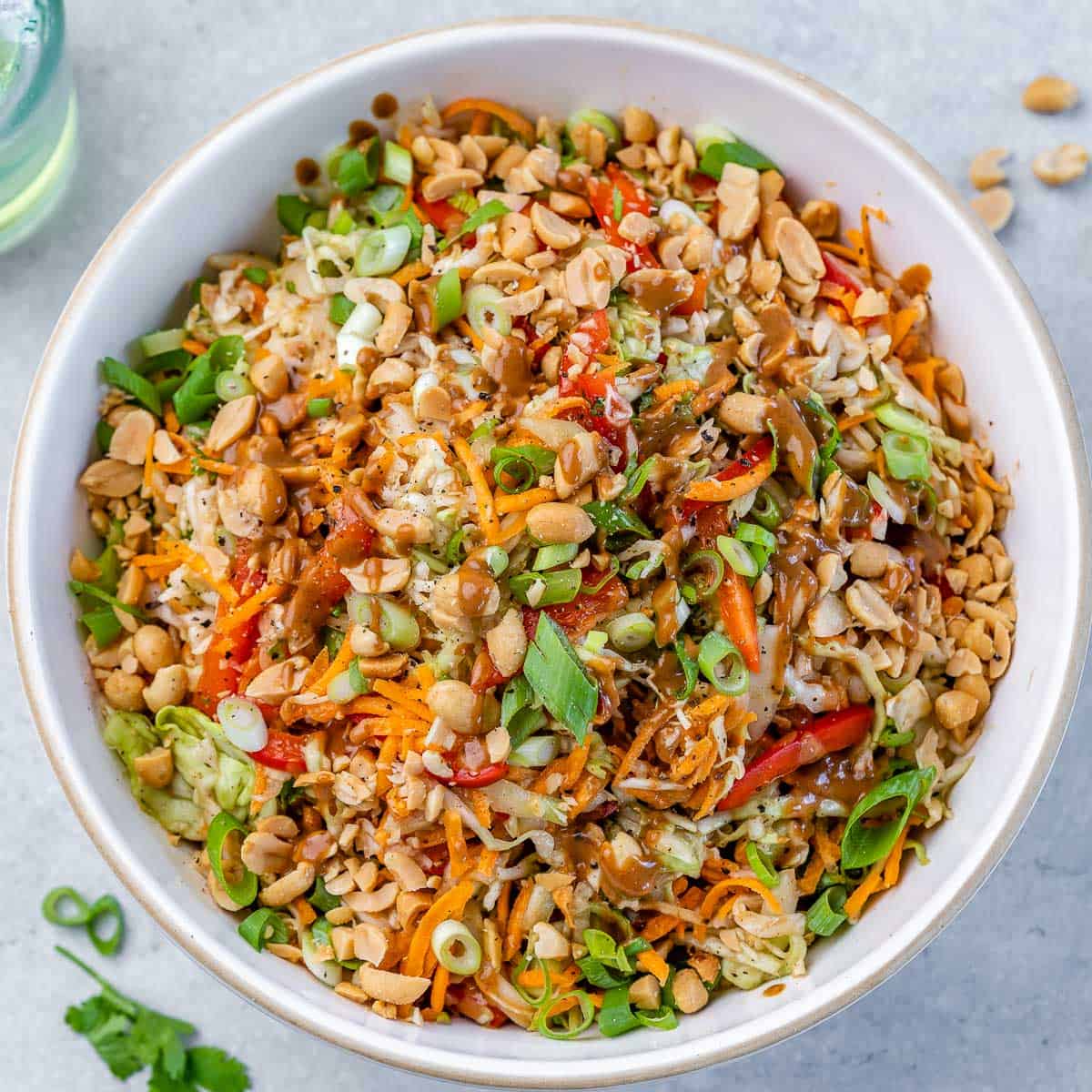 top view of white bowl containing thai peanut salad