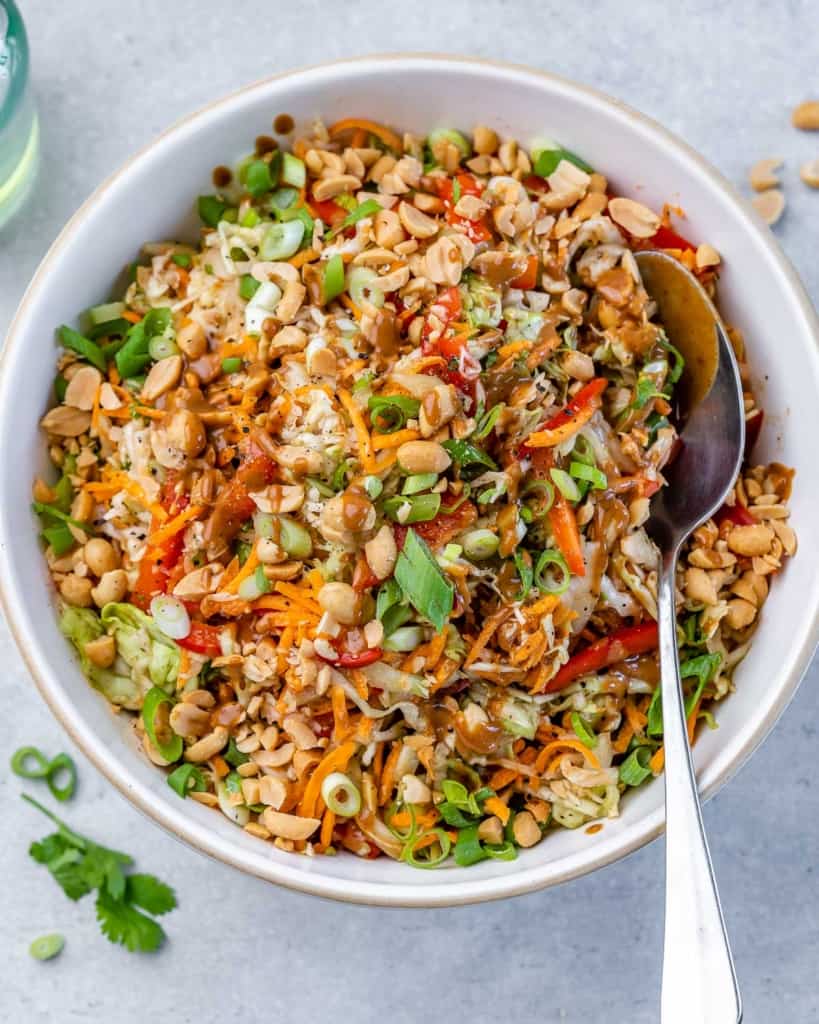 spoon in bowl with thai salad 