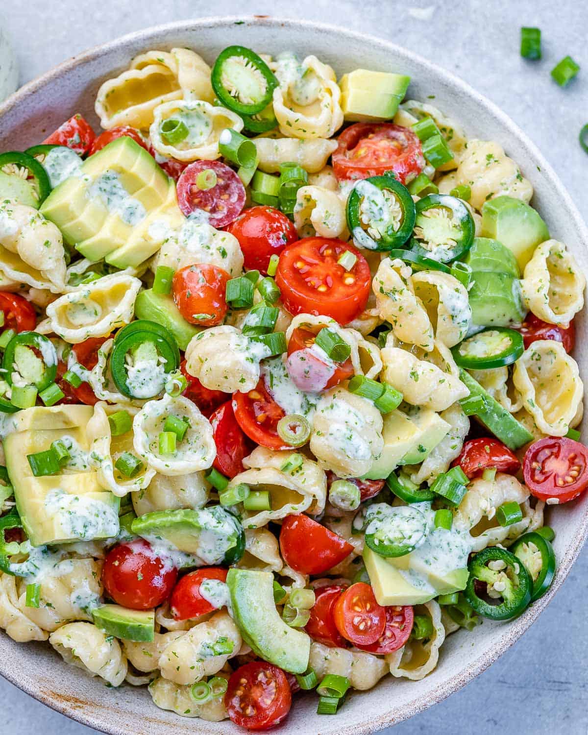 one bowl of cilantro lime pasta salad with avocado and creamy dressing