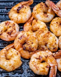 Shrimp on a black grill.