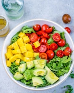 Overhead shot of salad ingredients in a white bowl.