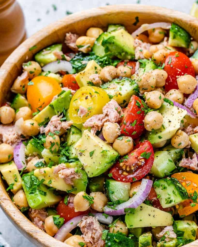 Chickpeas, veggies and avocado mixed in a salad bowl.