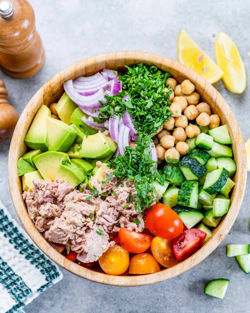 Ingredients for avocado chickpea tuna salad added to a large bowl.