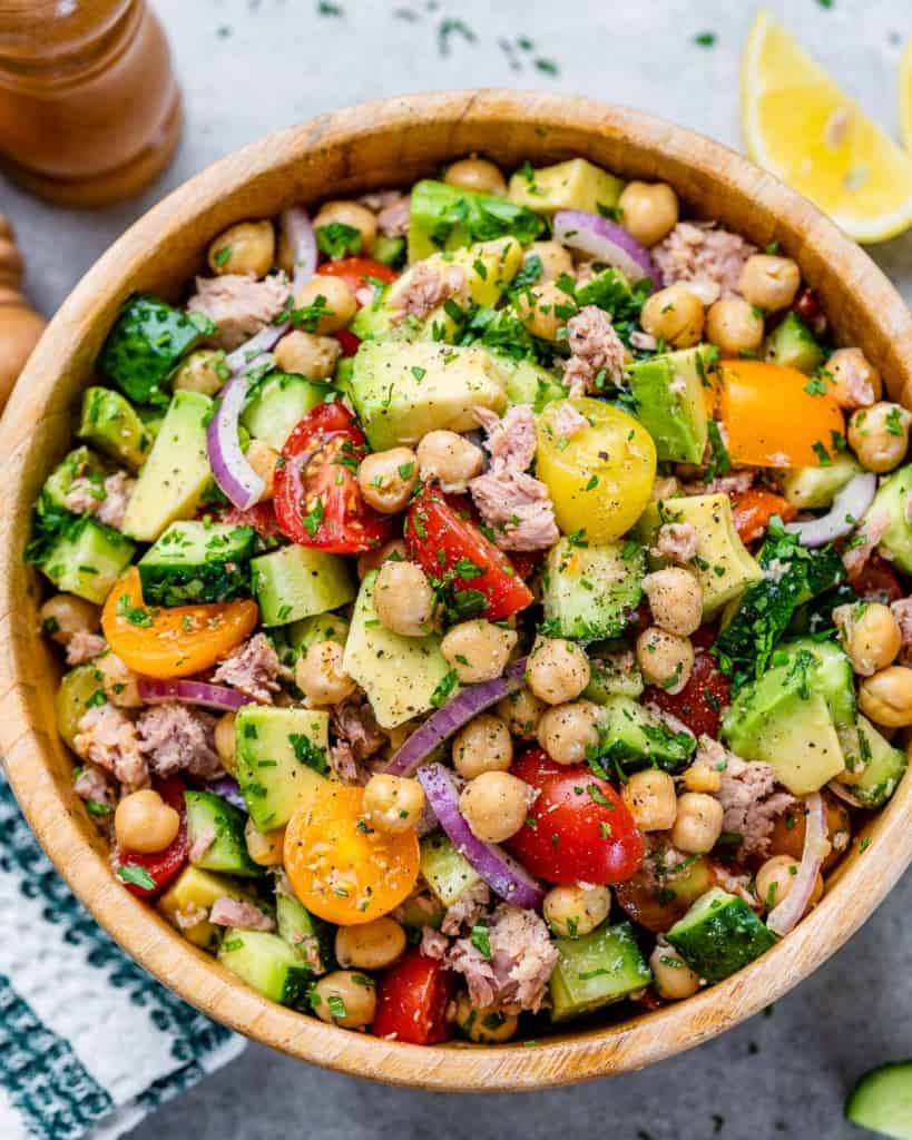 top closeup view of chickpea salad with tuna in a round wooden bowl