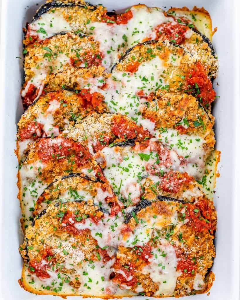 top view of baked eggplant parmesan in a white dish