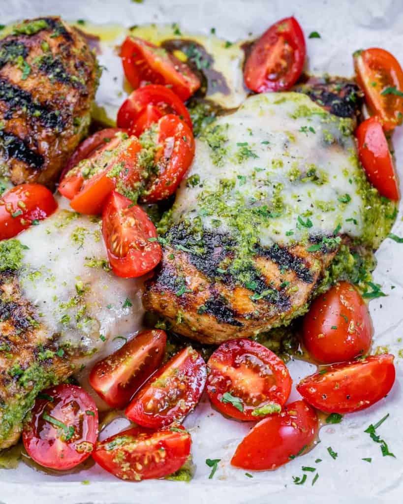 Chicken topped with cheese, pesto and tomatoes.