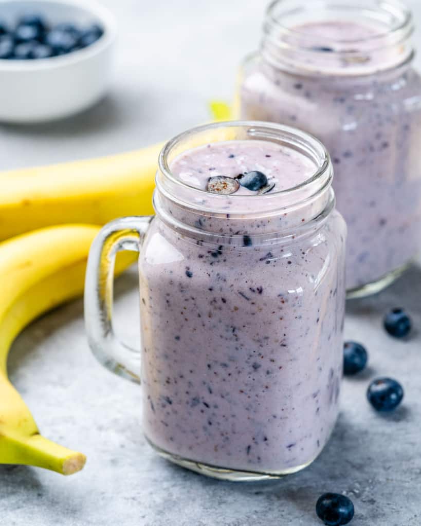 side shot of blueberry banana smoothie in a mason jar