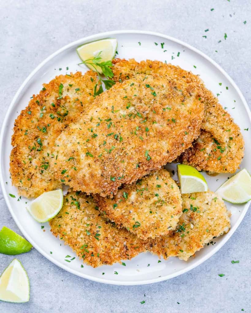 Chicken Milanese served on a white plate.