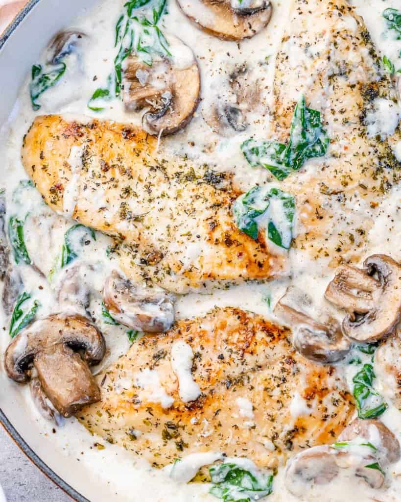 top view creamy chicken with spinach in a skillet