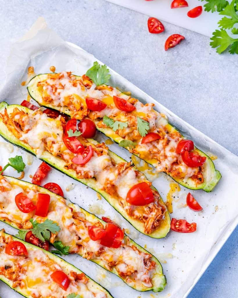 Zucchini boats served on a baking pan.