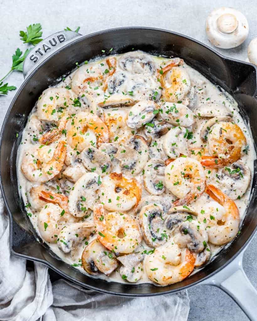 top view of creamy shrimp in a black skillet