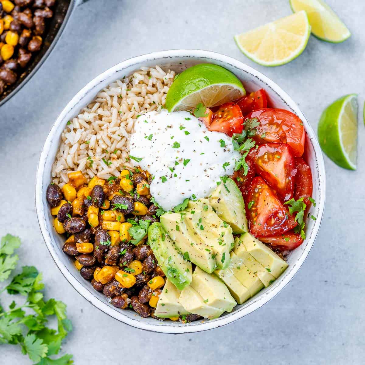 salad bowl with beans, avocado, tomato and sour cream