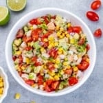 white bowl with shrimp salad with corn and tomatoes.