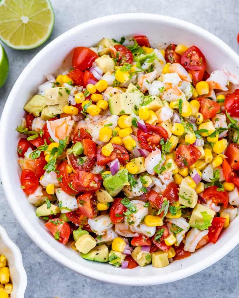 Salad made with tomatoes, corn, avocado and shrimp.