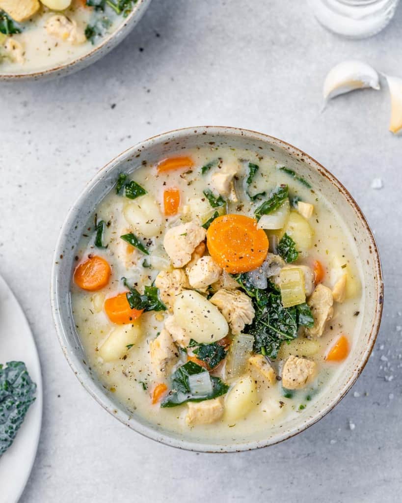 top view chicken and gnocchi soup with kale and veggies in a bowl