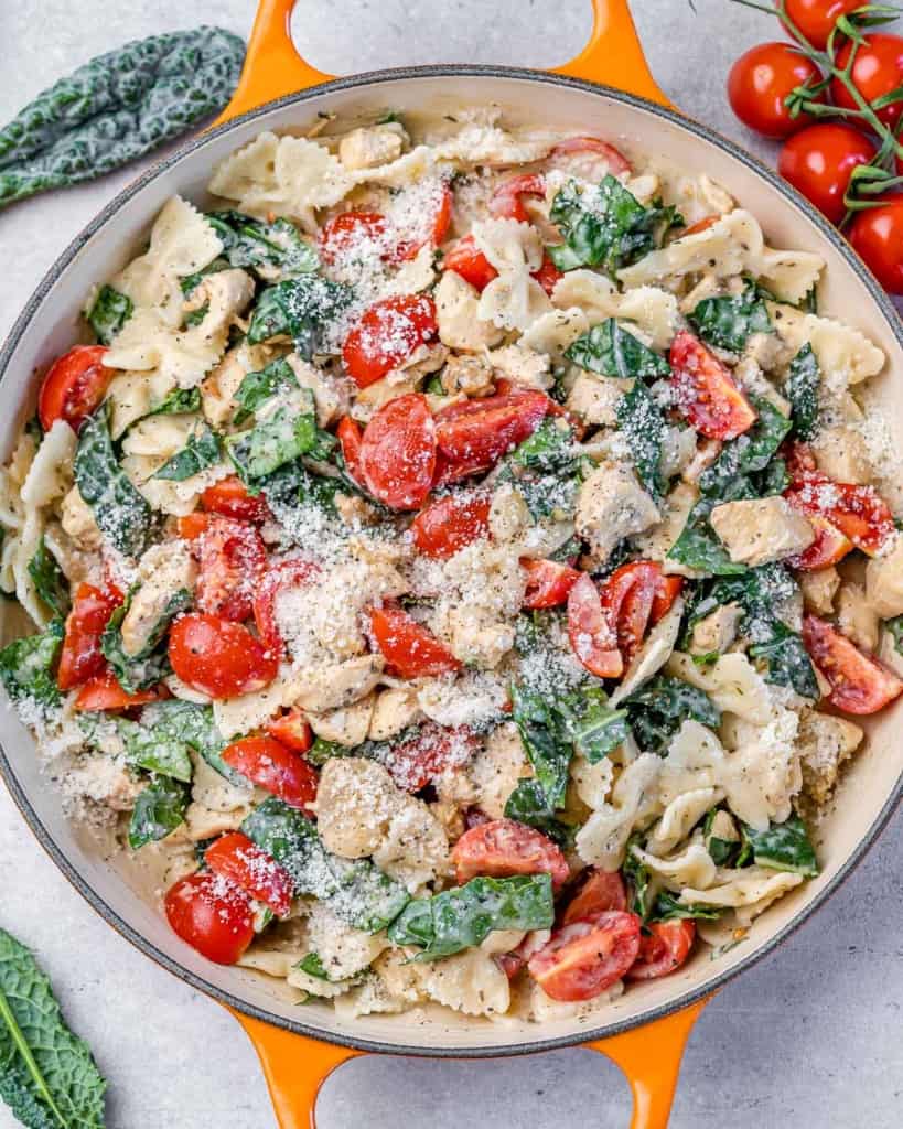 Pasta mixed with cherry tomatoes, kale and chicken in a creamy sauce.