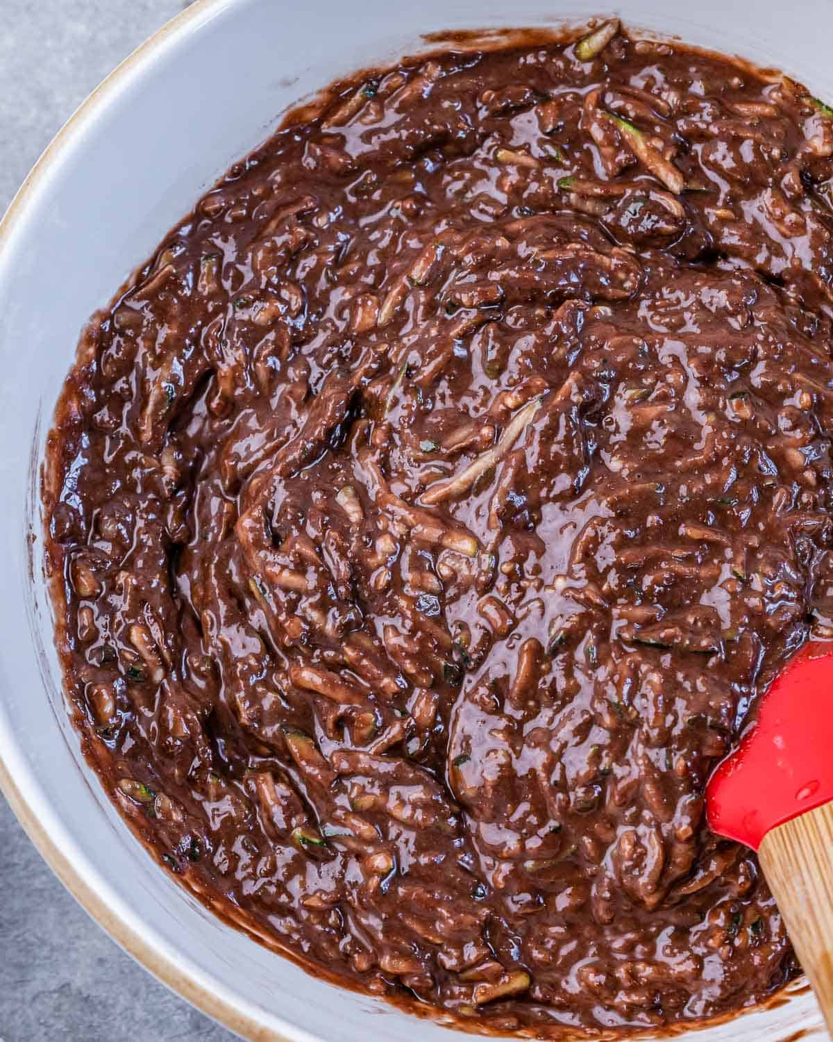 Stirring together brownie batter in a large bowl.