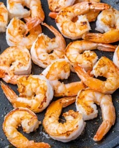 Large shrimp cooking in a skillet.