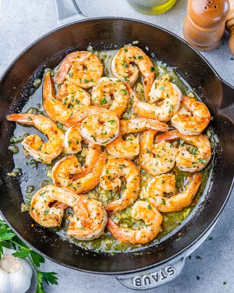 top view shrimp scampi cooked in a black skillet