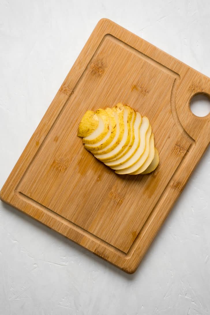 sliced pear atop wooden board 