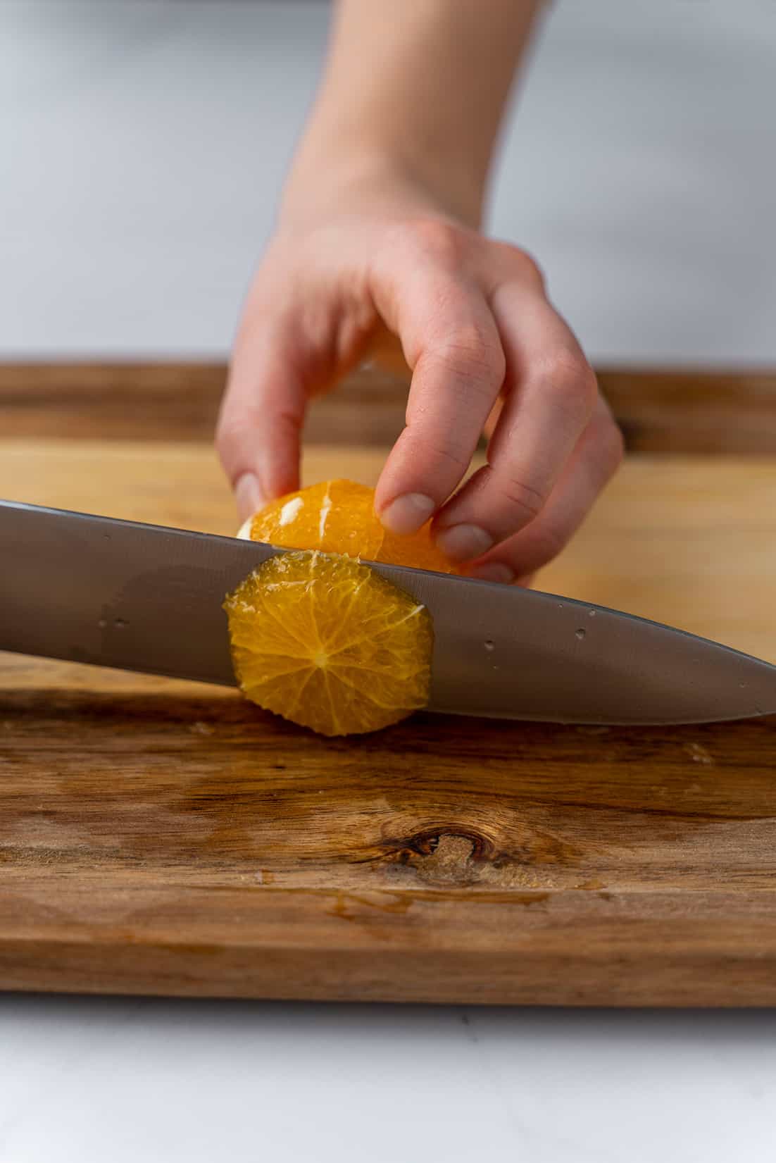 slicing an orange with a knife 