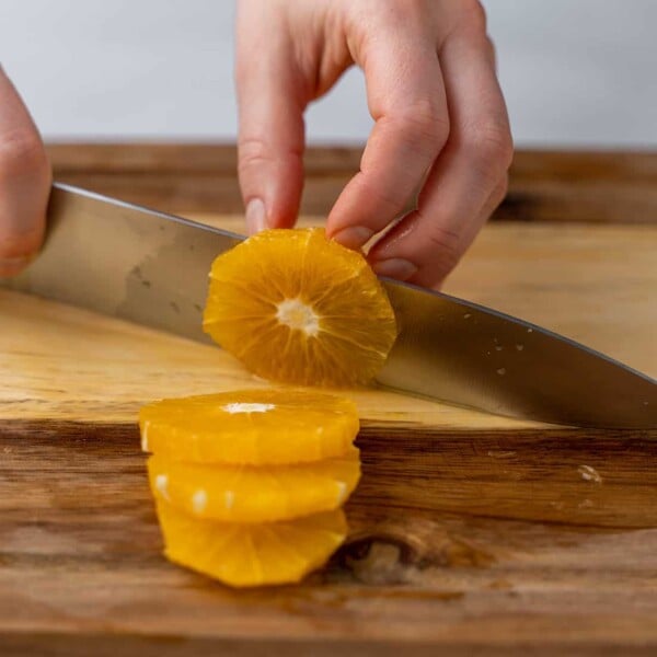 cutting an orange with knife