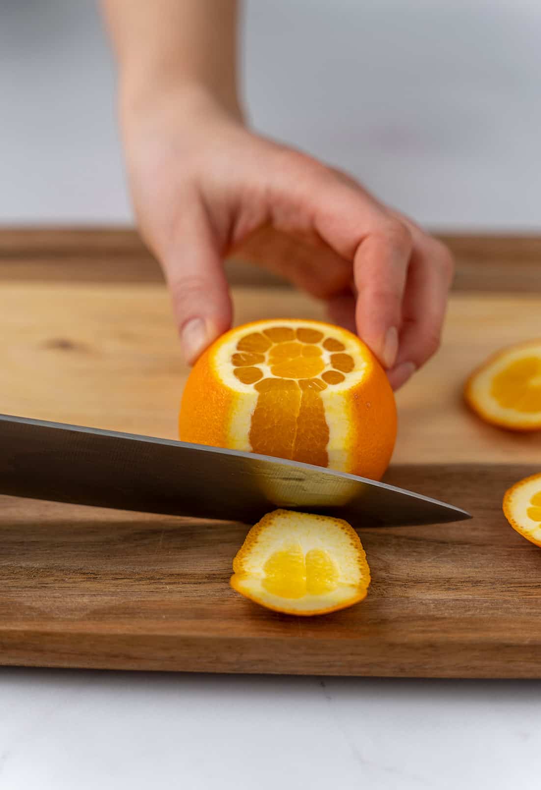 slicing the peel off the orange 