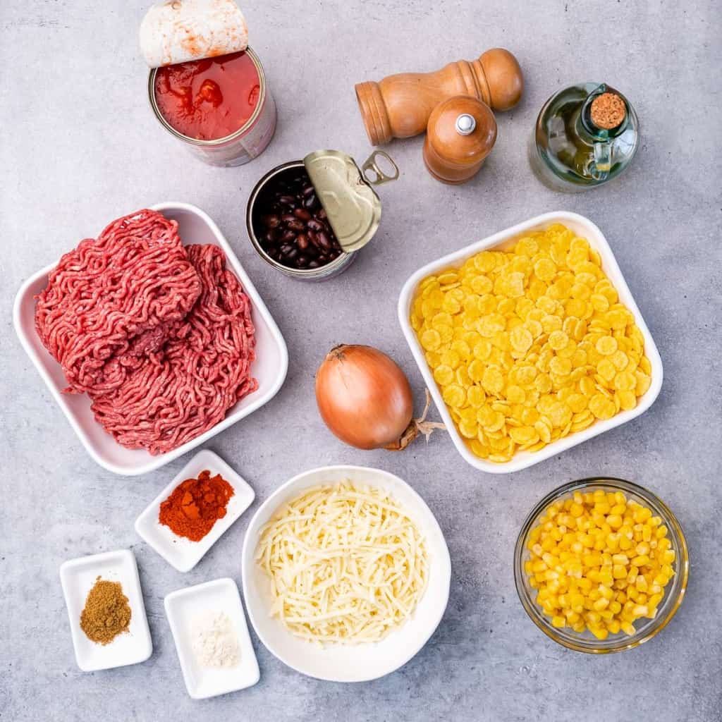 Ingredients to make taco casserole divided into small portions.