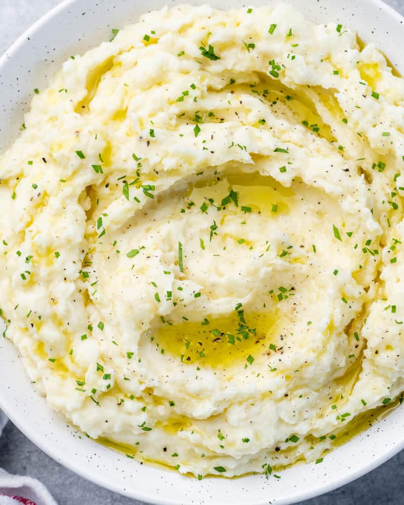 Potatoes mashed in a white serving bowl.