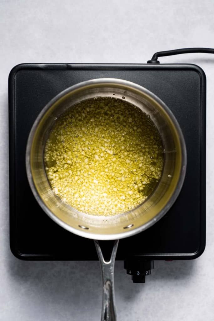Garlic simmering in oil.