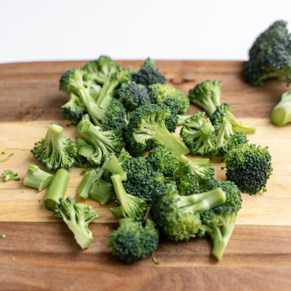 chopped broccoli florets on a cutting board for a how to cut broccoli into florets tutorial