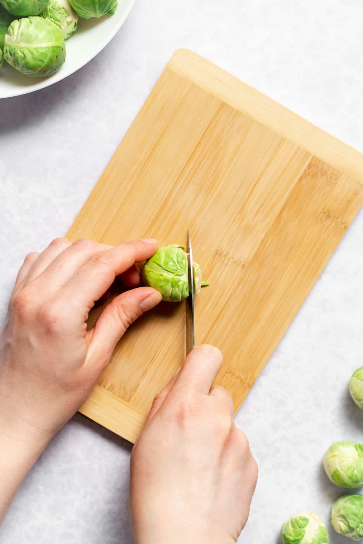 trimming the brussels sprout with knife 