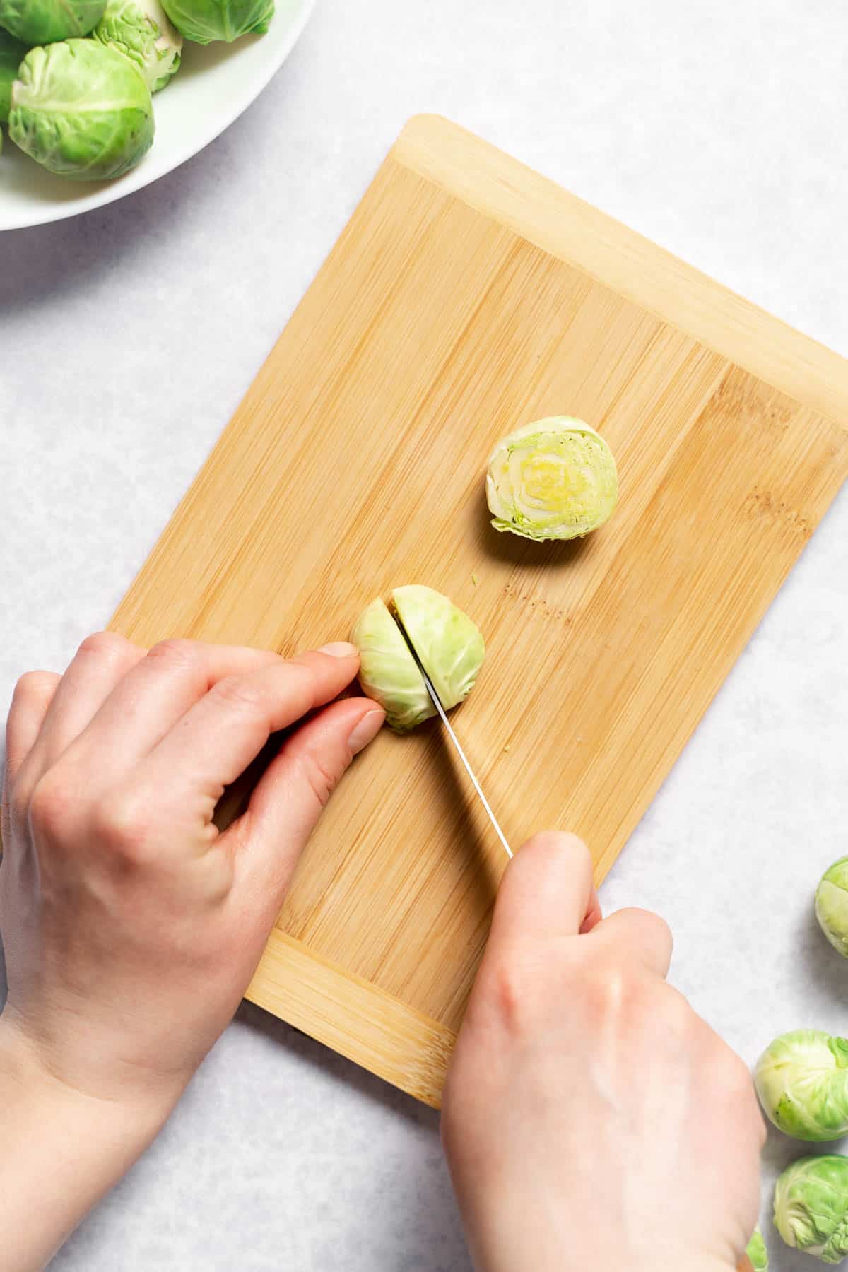 slicing the brussels sprout into fourths 