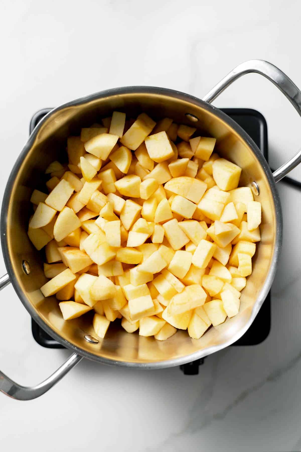 sliced apples in pot with water