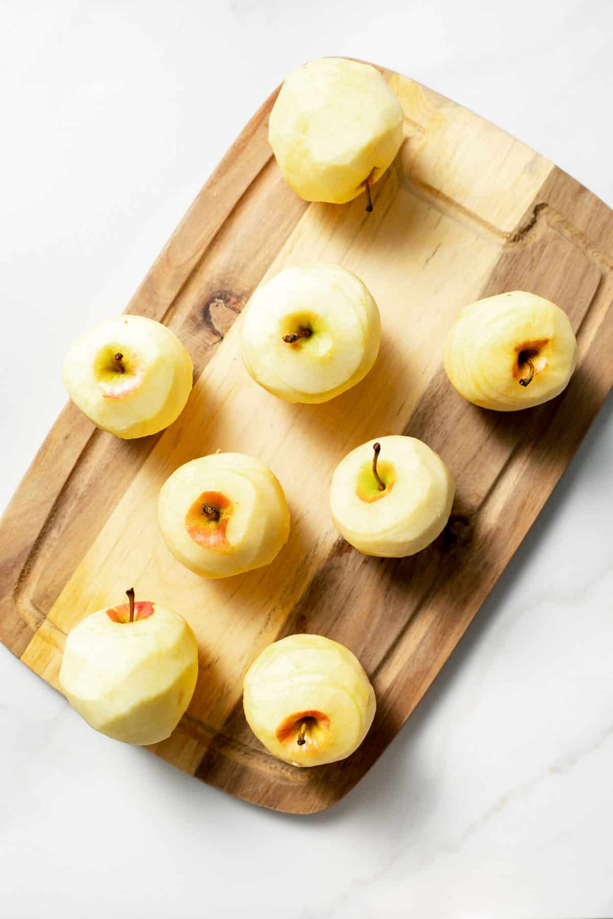 peeled apples on cutting board
