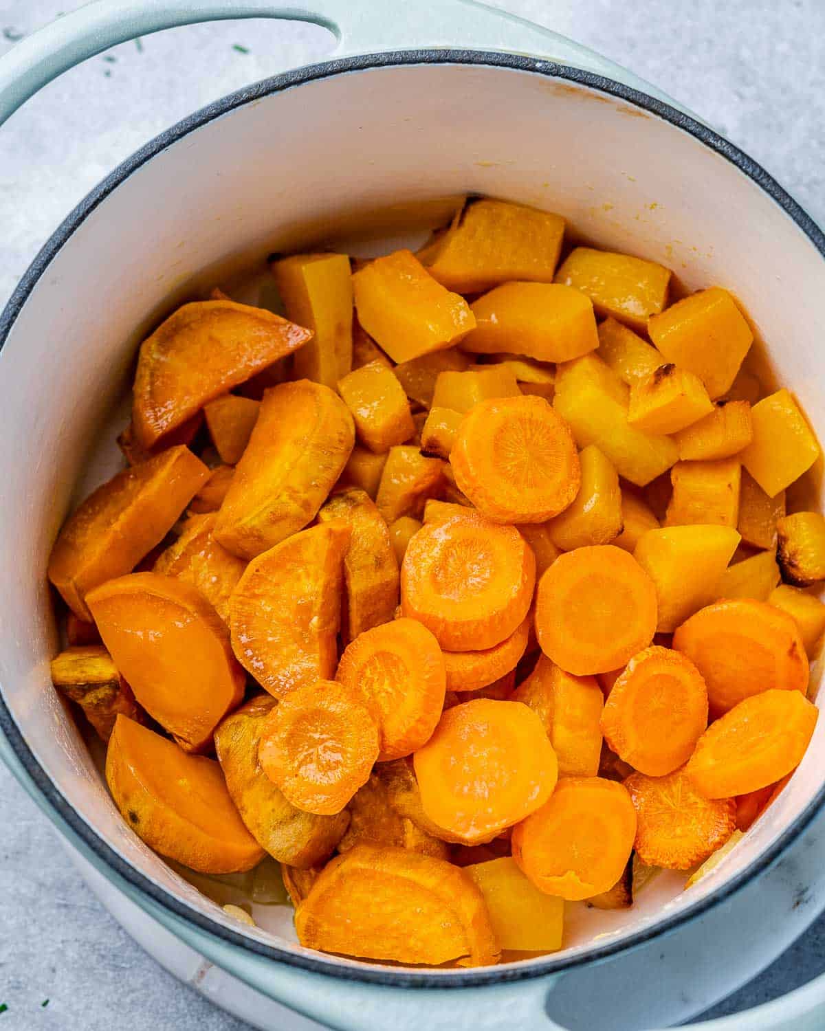 roasted carrots, sweet potatoes, and butternut squash in a pot