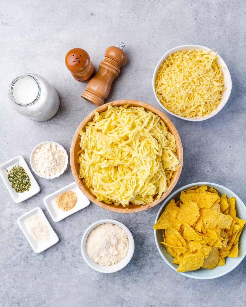 Shredded potatoes and grated cheese separated into bowls.