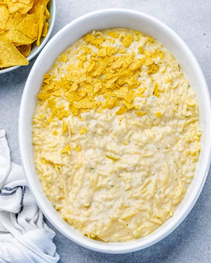 Topping casserole with corn chips.
