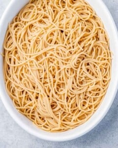 Spaghetti noodles in a white casserole dish.