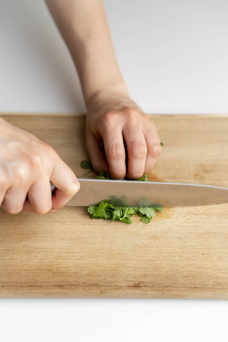 slicing the cilantro leaves with a knife