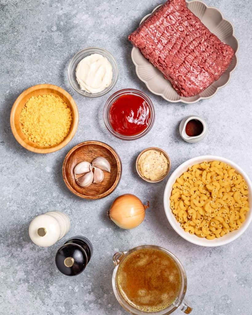 Ingredients to make cheeseburger casserole divided into small bowls.