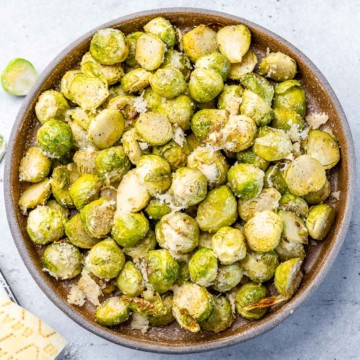 top view roasted brussel sprouts in a brown bowl