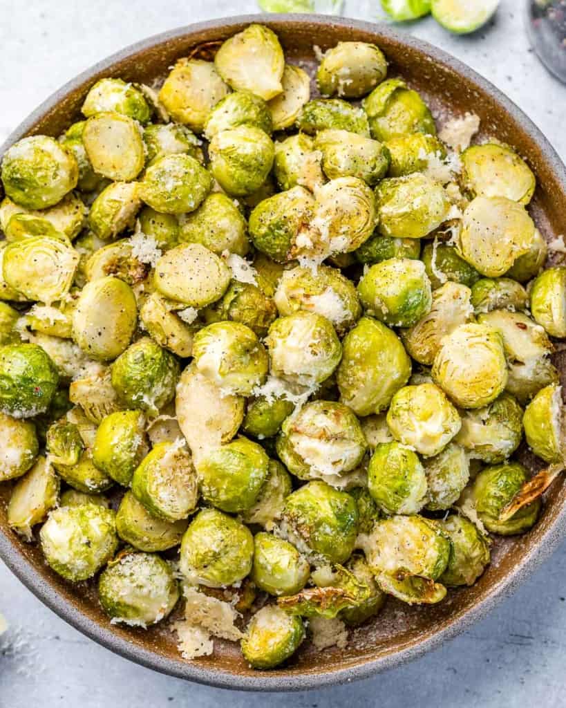 Oven Roasted Brussels sprouts topped with parmesan cheese.