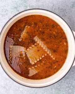 Lasagna noodles simmering in soup.