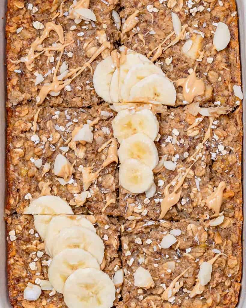 Baked oatmeal cut into squares and topped with sliced banana.