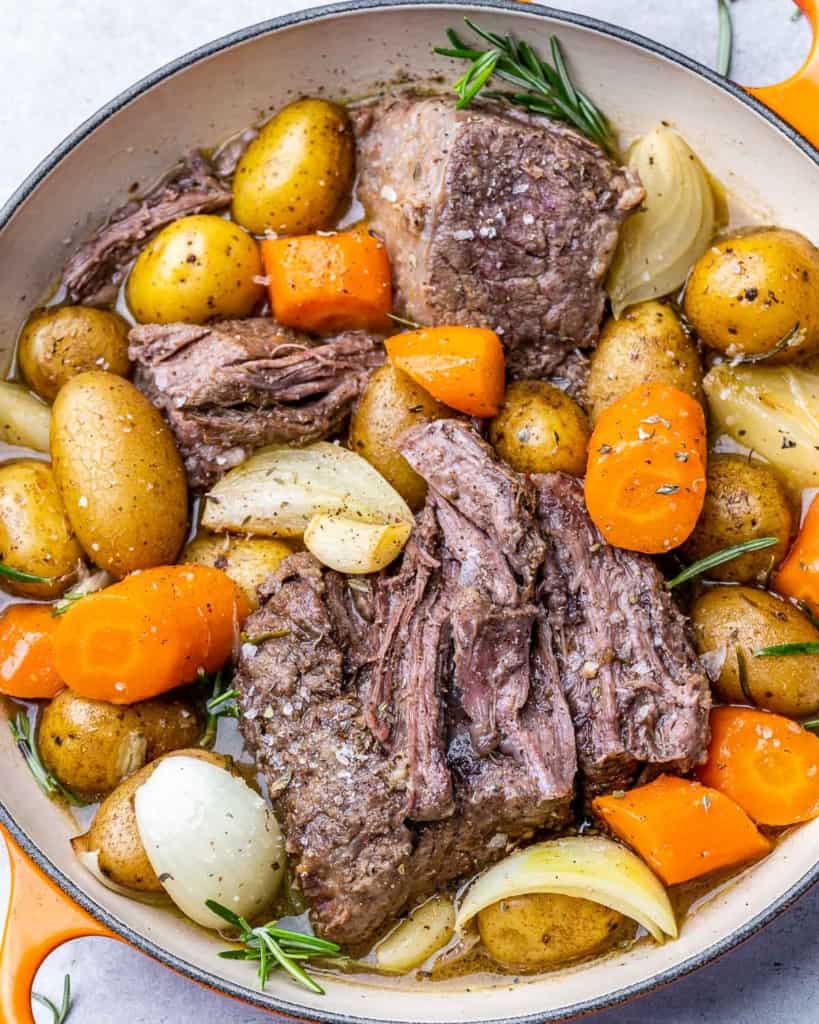 top view beef with carrots and potatoes in an orange pot