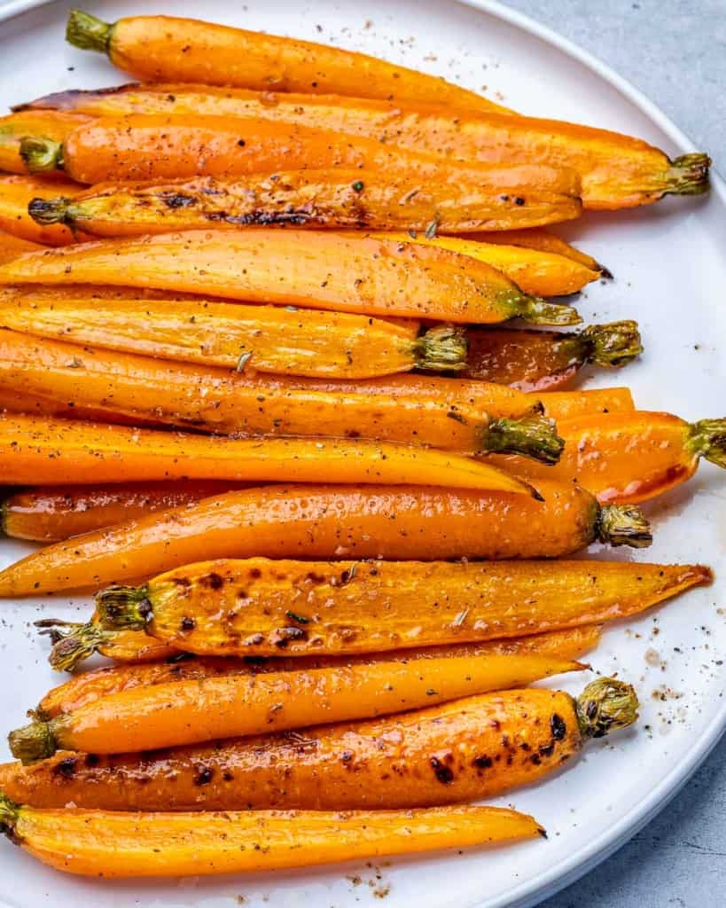 Roasted carrots on a white plate.