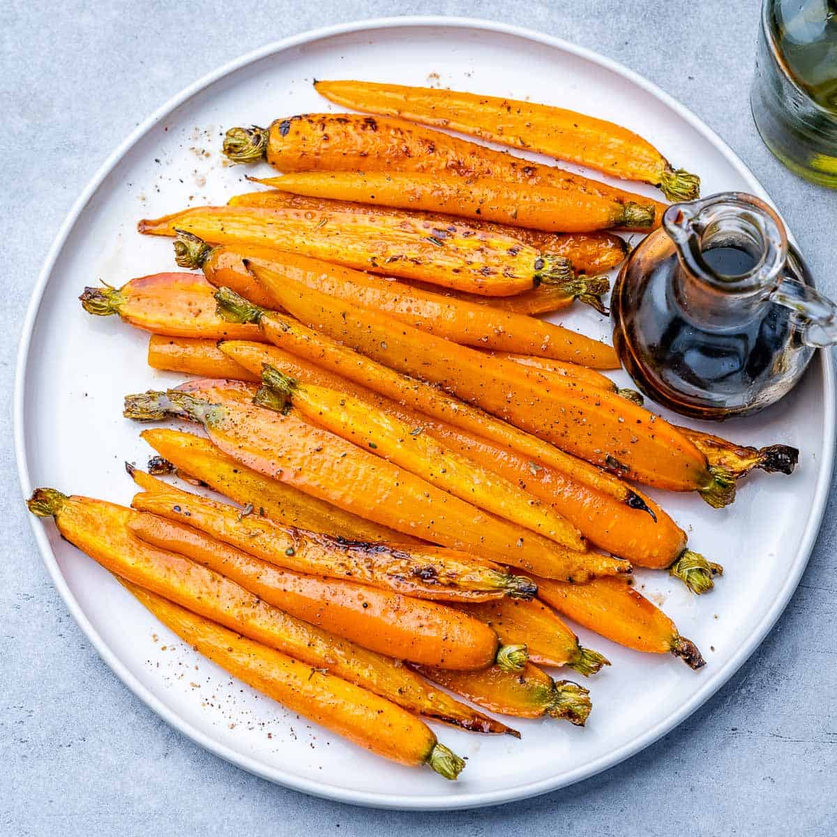 top view of glazed carrots on a round white plate
