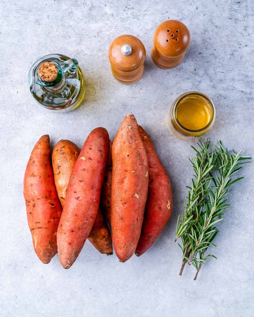 Sweet potatoes with sprigs of rosemary, honey and olive oil.